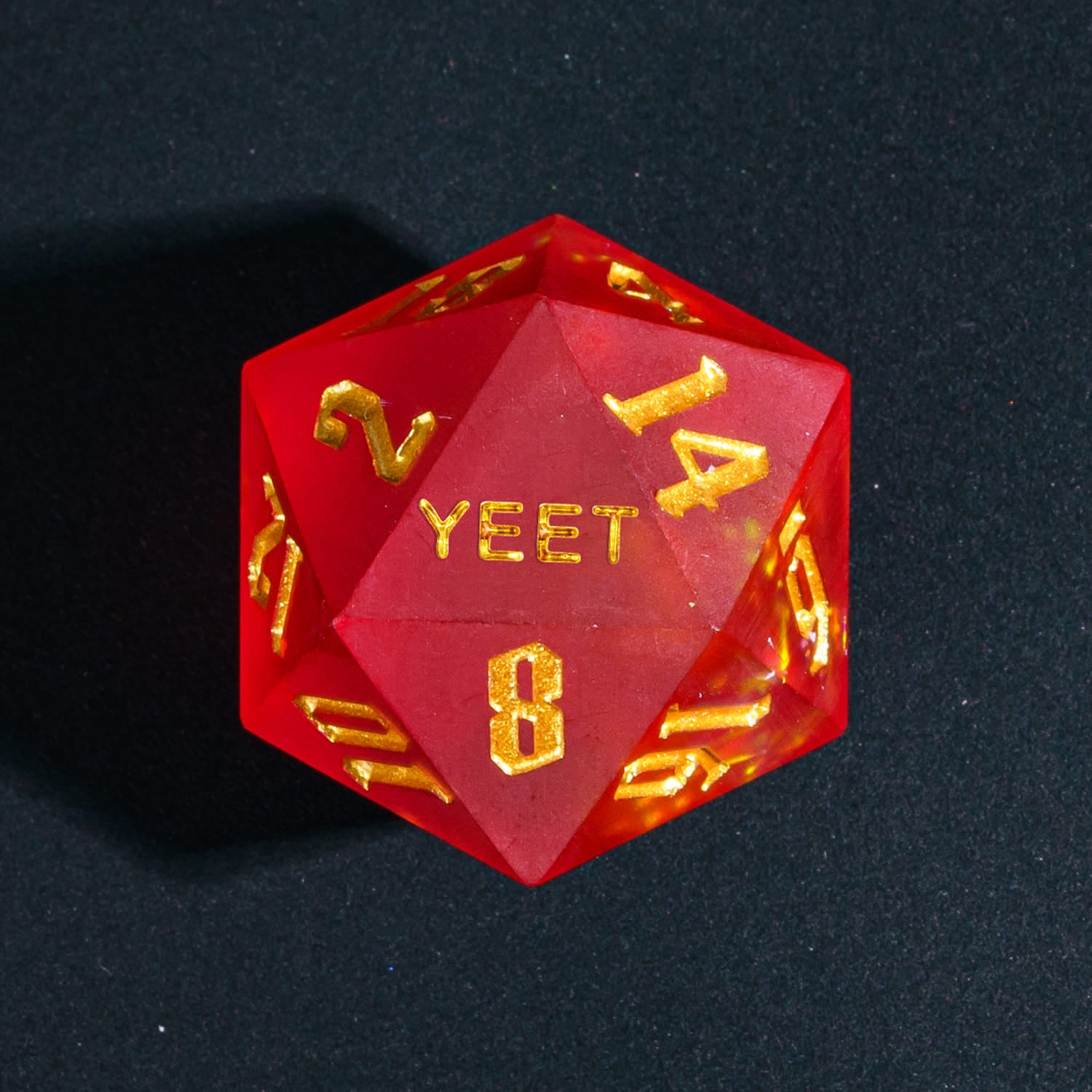 Close up of Frosted Ember Sharp Edge D20 with YEET face for DnD dice