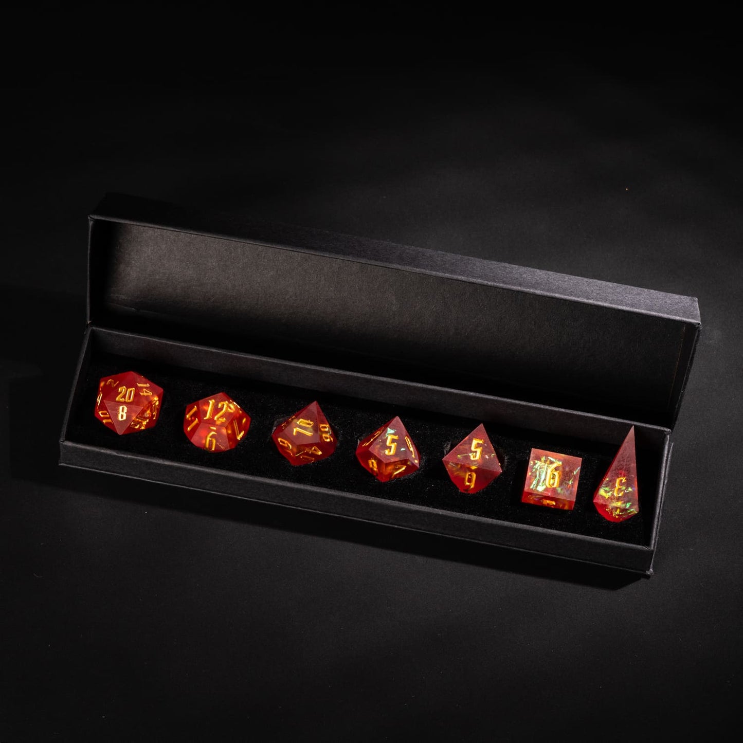 Frosted Ember sharp edge resin 7-piece dice set in black presentation box with gold numbering and fiery inclusions.