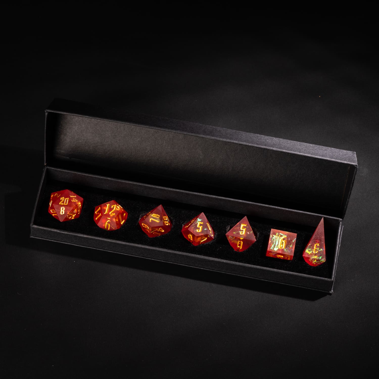 Frosted Ember sharp edge resin 7-piece dice set in black presentation box with gold numbering and fiery inclusions.