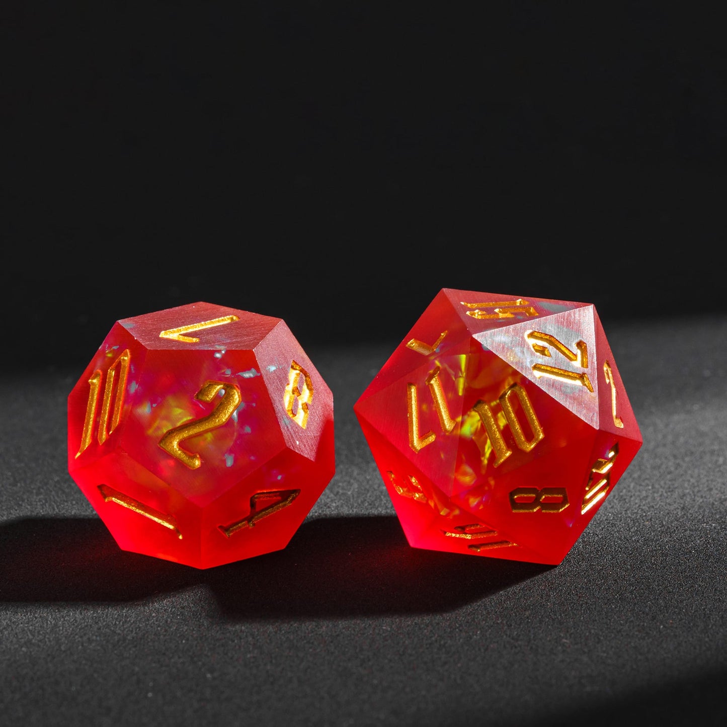 Frosted Ember sharp edge resin D12 and D20 featuring fiery yellow inclusions and gold engraved numbers