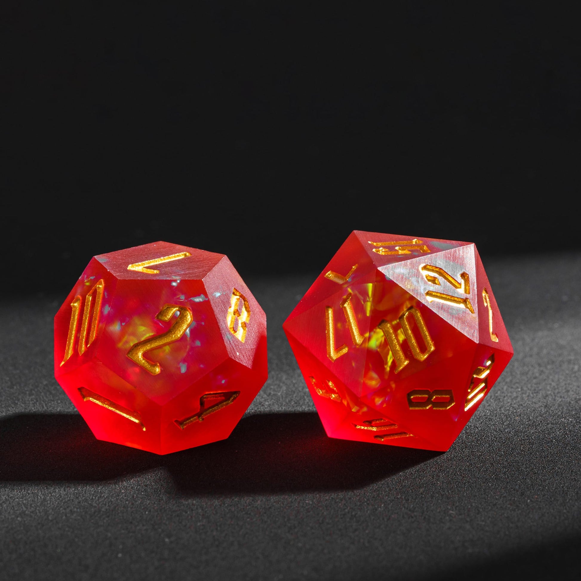 Frosted Ember sharp edge resin D12 and D20 featuring fiery yellow inclusions and gold engraved numbers