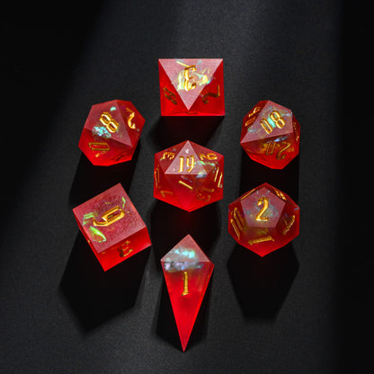 Frosted Ember sharp edge resin 7-piece dice set displayed on dark background with gold numbering and ember-like inclusions.