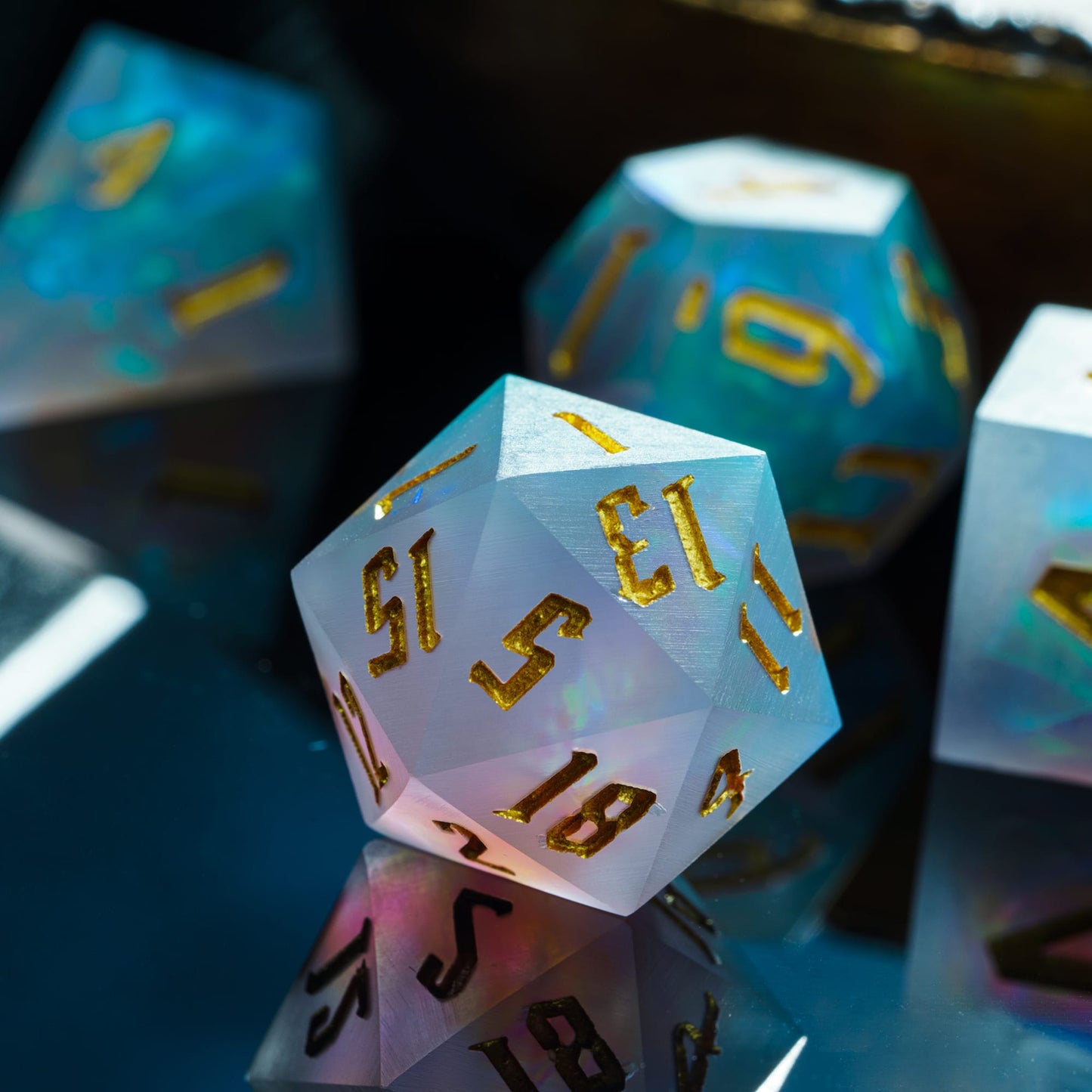 Macro shot of Frosted Mirage D20 with sharp edges, frosted resin, gold numbers & blue shimmer for DnD