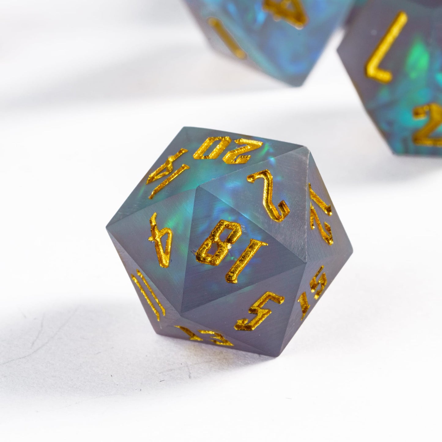 Frosted Mirage D20 with golden numbers & shimmering resin core styled for dramatic tabletop display
