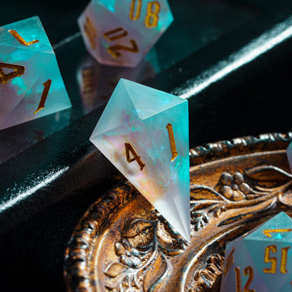 Frosted Mirage D4 sharp edge die with frosted resin & glowing blue core styled on decorative tray