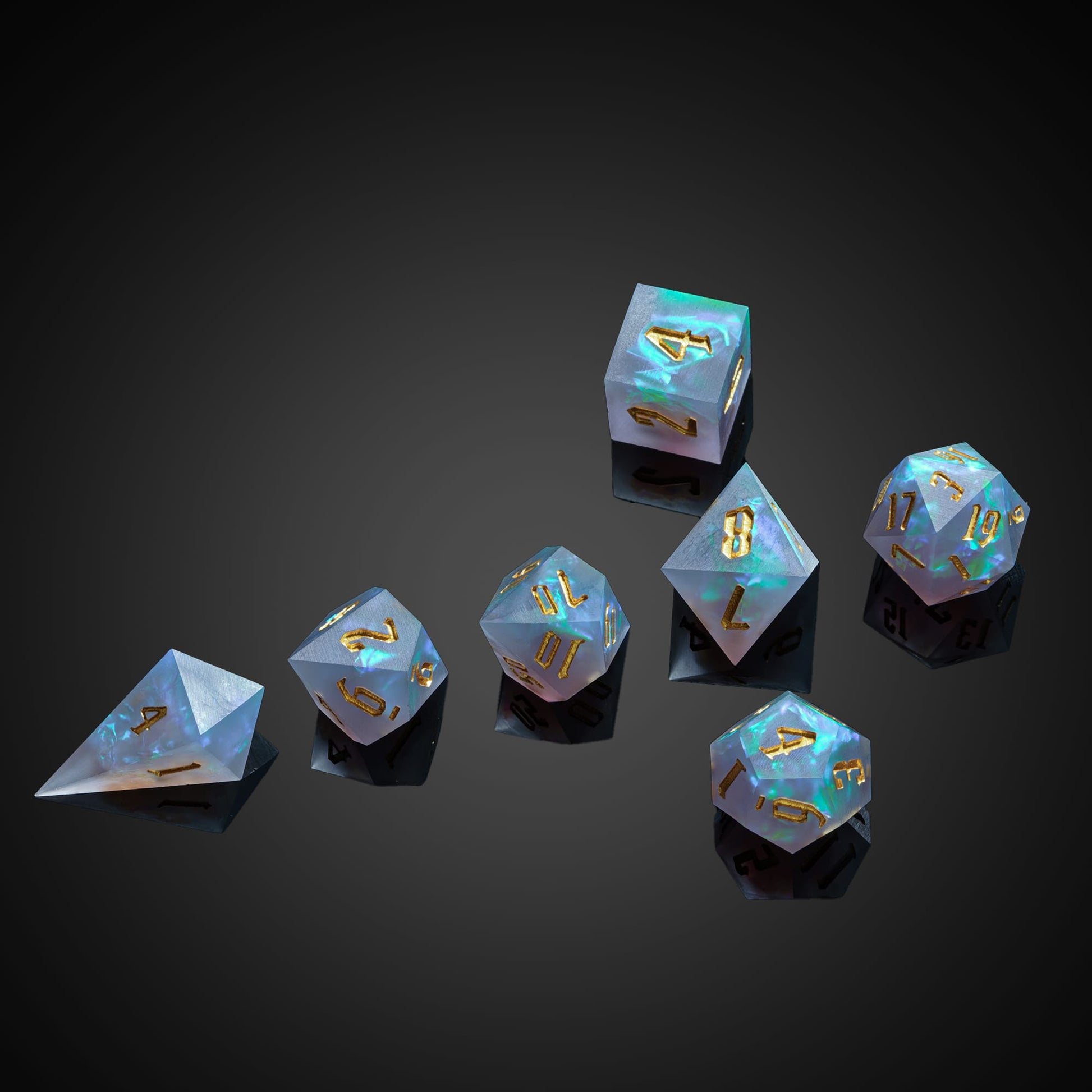Frosted Mirage Sharp Edge Dice Set arranged on dark background highlighting glowing blue resin core