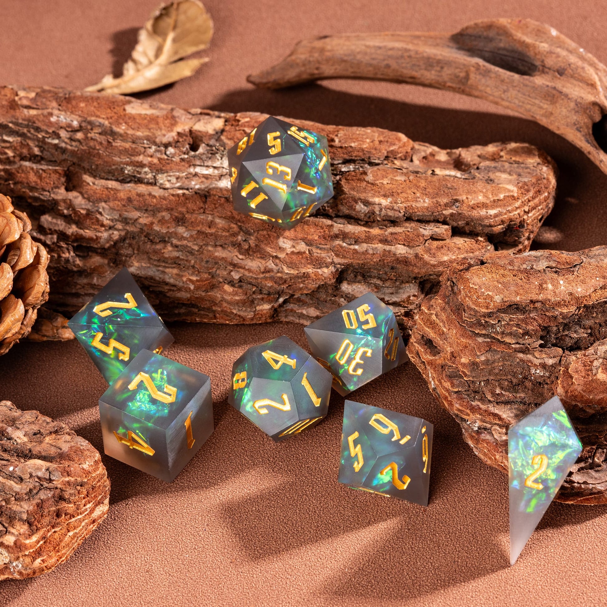 Flat lay of Frosted Mirage sharp edge 7 piece dice set with frosted resin and green iridescent inclusions