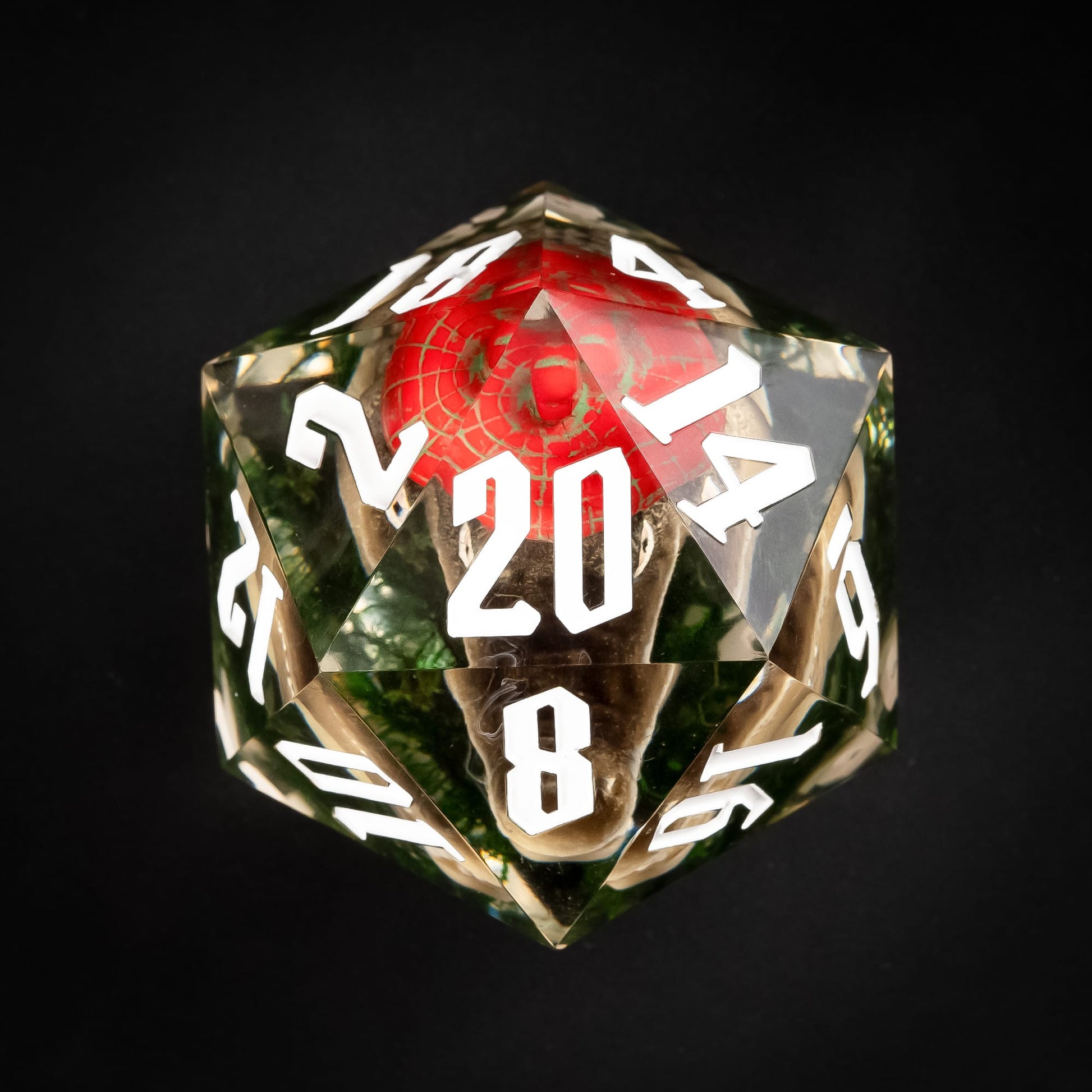 Top view of oversized red gator D20 with embedded miniature