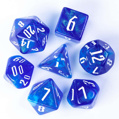 Flat lay of Glacier Blue Dice Set 7 piece resin polyhedral dice with white ink for DnD
