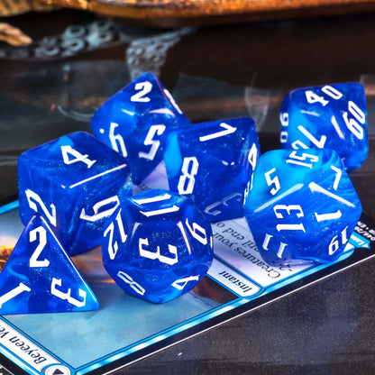 Glacier Blue Dice Set shimmering resin polyhedral dice on table background for DnD