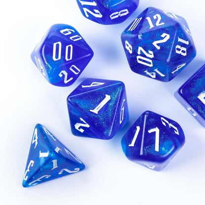 Glacier Blue Dice Set resin polyhedral dice stacked on book for DnD and tabletop roleplaying games