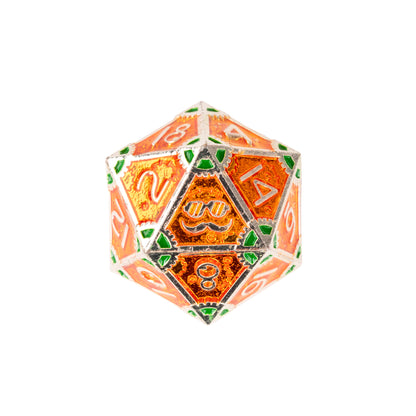 Close-up of the Guillman's Guilded Metal Dice Set D20 showcasing orange translucent resin, silver metal framework, green accents, and engraved numbering
