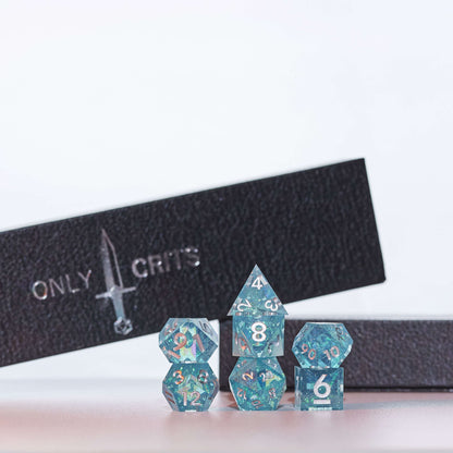  Icy Shard dice set stacked for display with Only Crits box, teal resin dice with silver numbering
