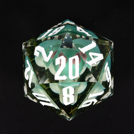 Top view of oversized green kobold D20 with embedded miniature