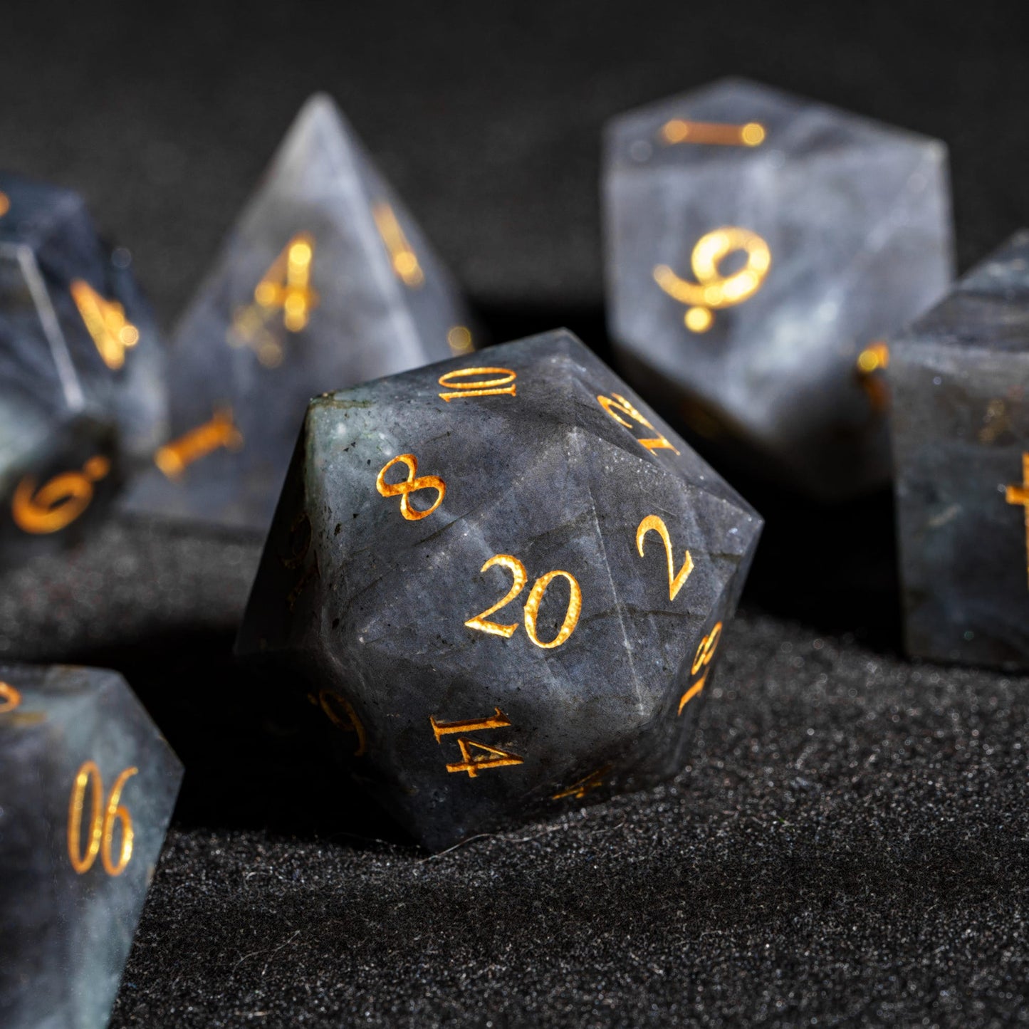 Labradorite Essence stone D20 made from genuine labradorite gemstone with dark blue-gray marbling and easy-to-read gold numbers
