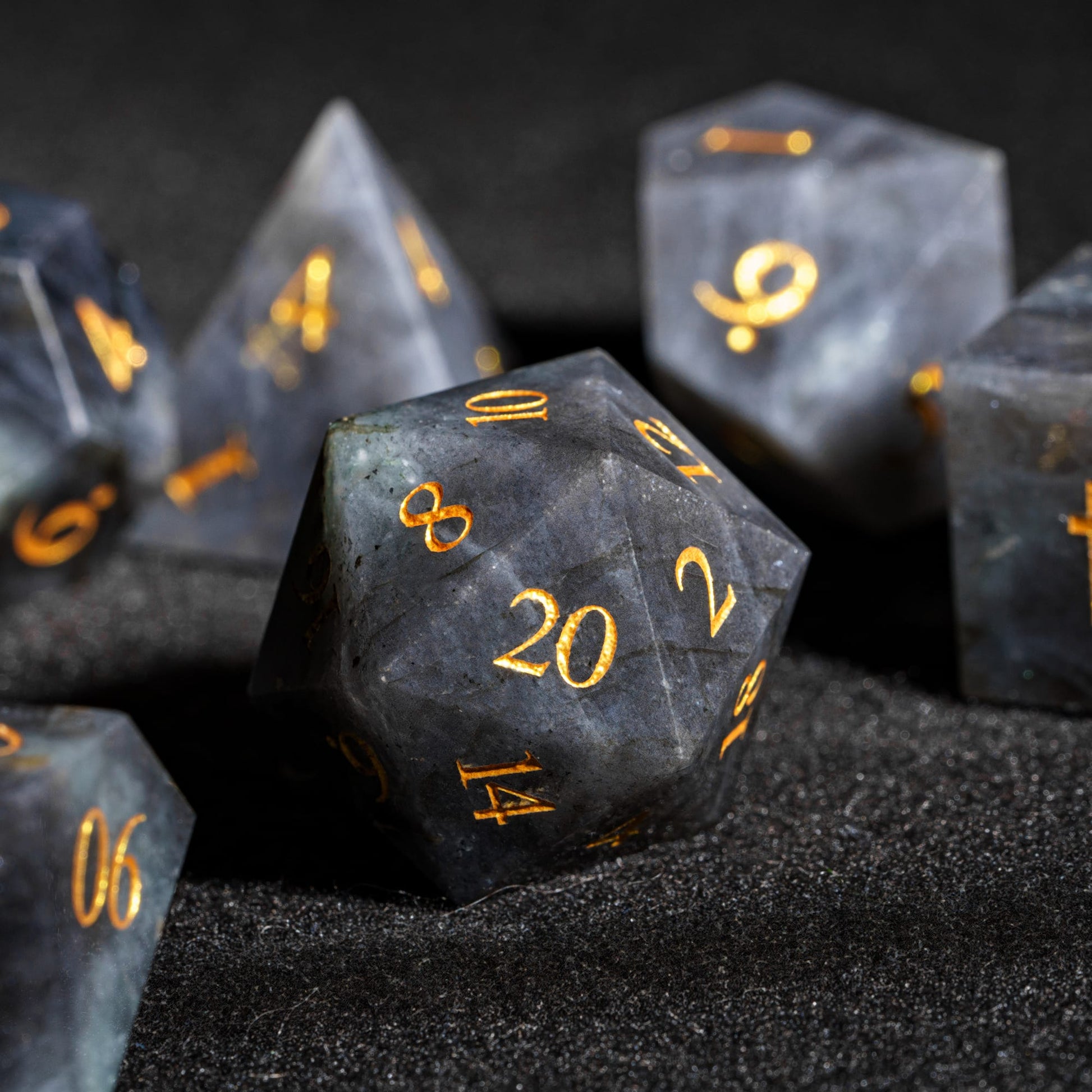 Labradorite Essence stone D20 made from genuine labradorite gemstone with dark blue-gray marbling and easy-to-read gold numbers