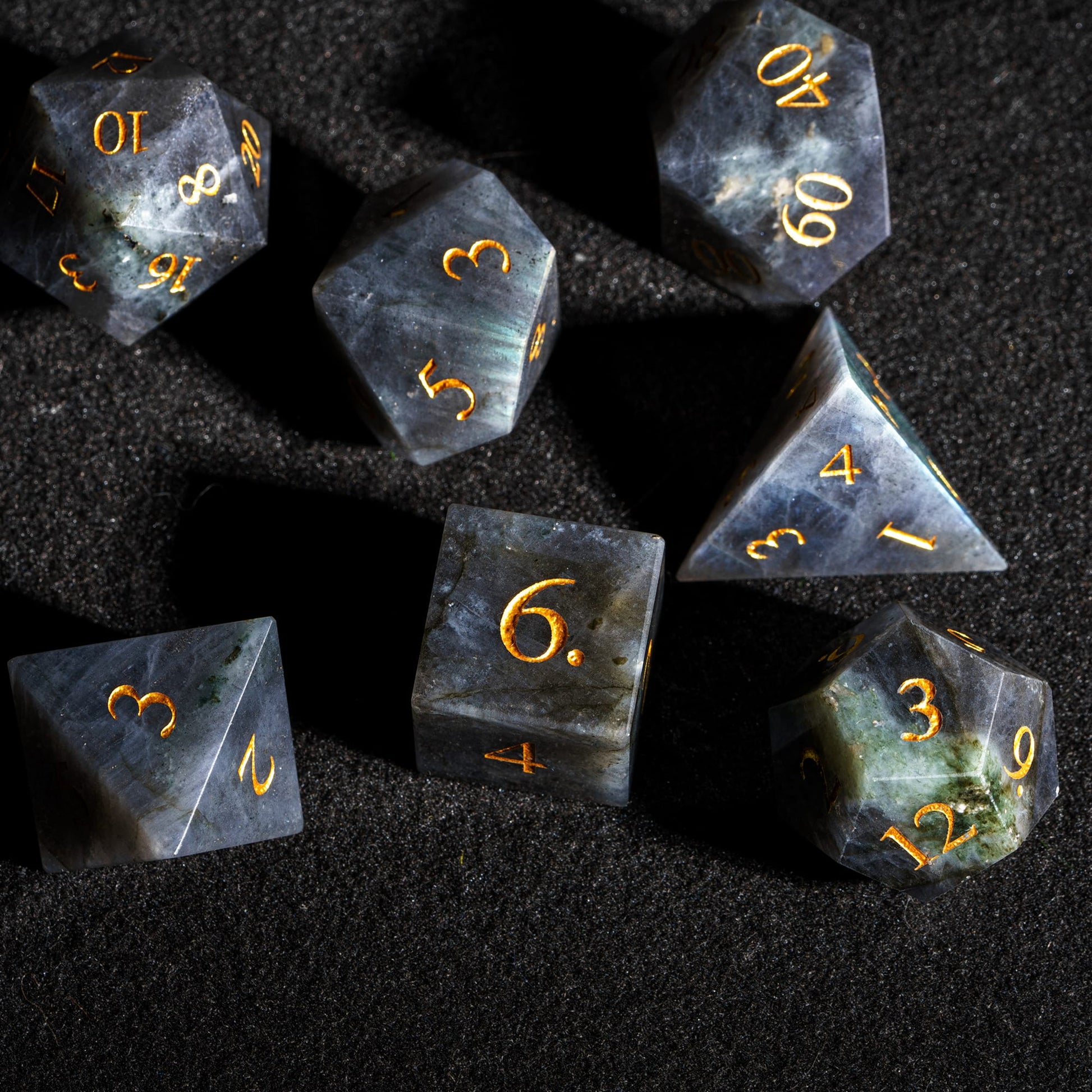 Top view of Labradorite Essence stone dice set featuring genuine labradorite gemstone dice with polished surfaces and gold numbering.