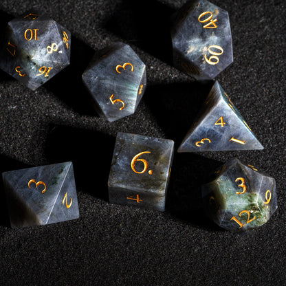 Top view of Labradorite Essence stone dice set featuring genuine labradorite gemstone dice with polished surfaces and gold numbering.