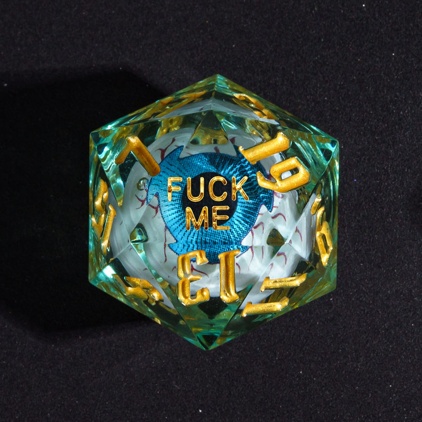 Close up of Liquid Core Eye Blue Fuck Me D20 Sharp Edge Die with blue eye core for DnD