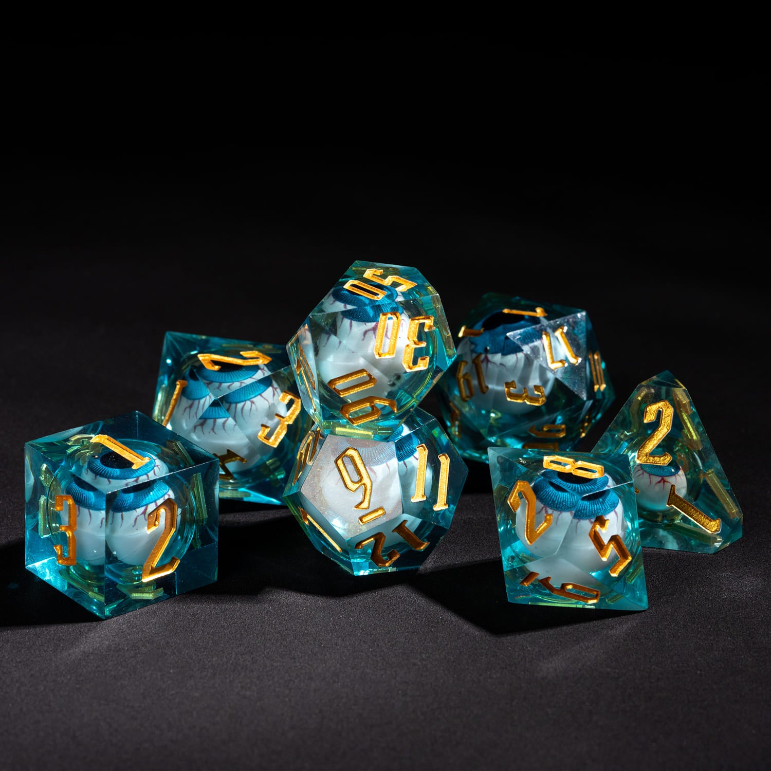 Liquid Core Eye Blue Sharp Edge Dice Set arranged on black background 7 piece resin dice for DnD tabletop RPG