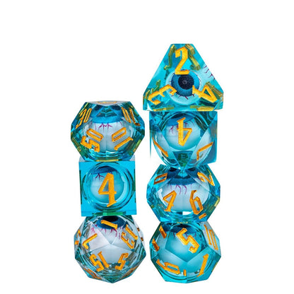 Vertical stack of Liquid Core Eye Blue Sharp Edge Dice Set 7 piece translucent aqua resin dice for DnD