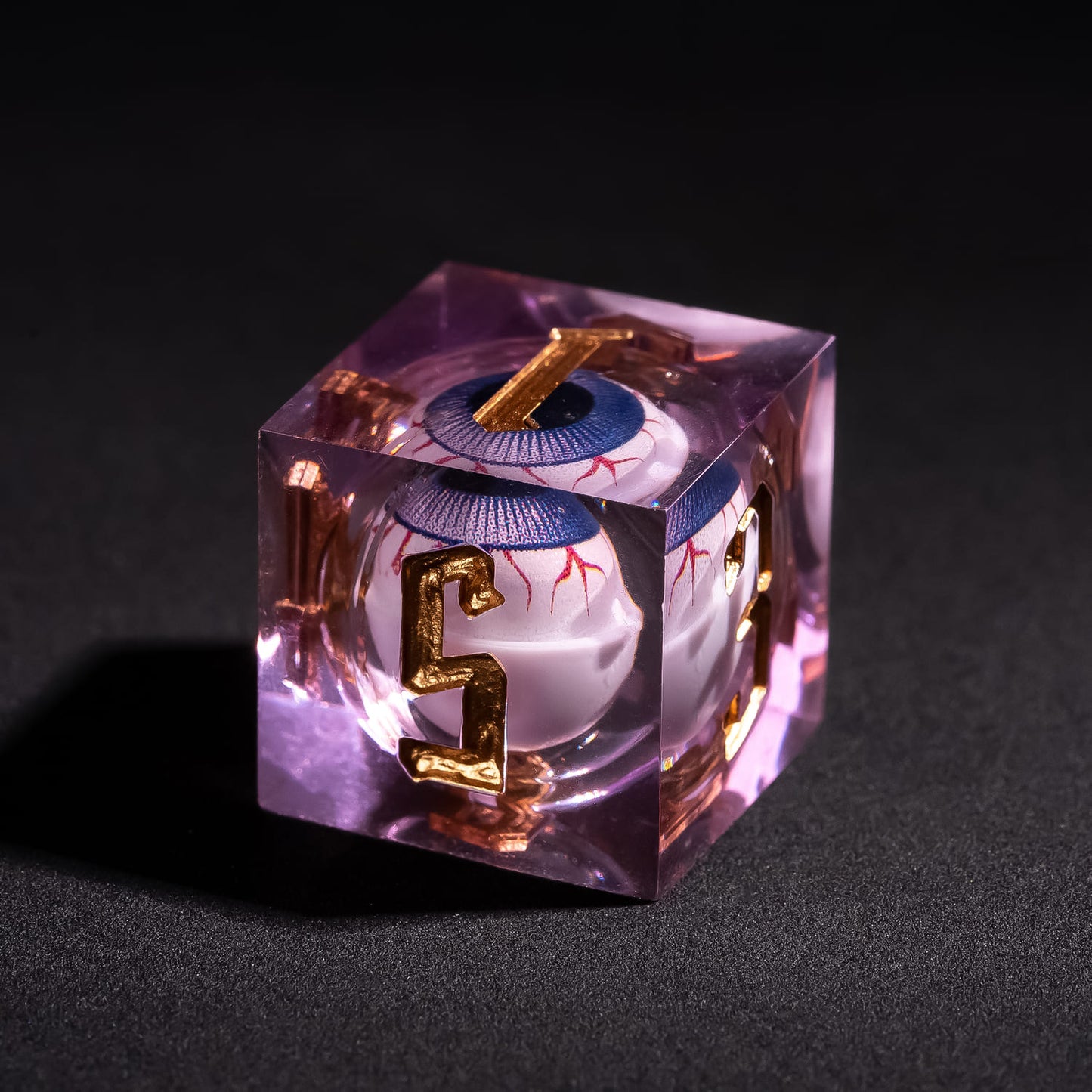 Close up of Liquid Core Eye Purple Sharp Edge D6 showing floating purple eye core inside translucent violet resin