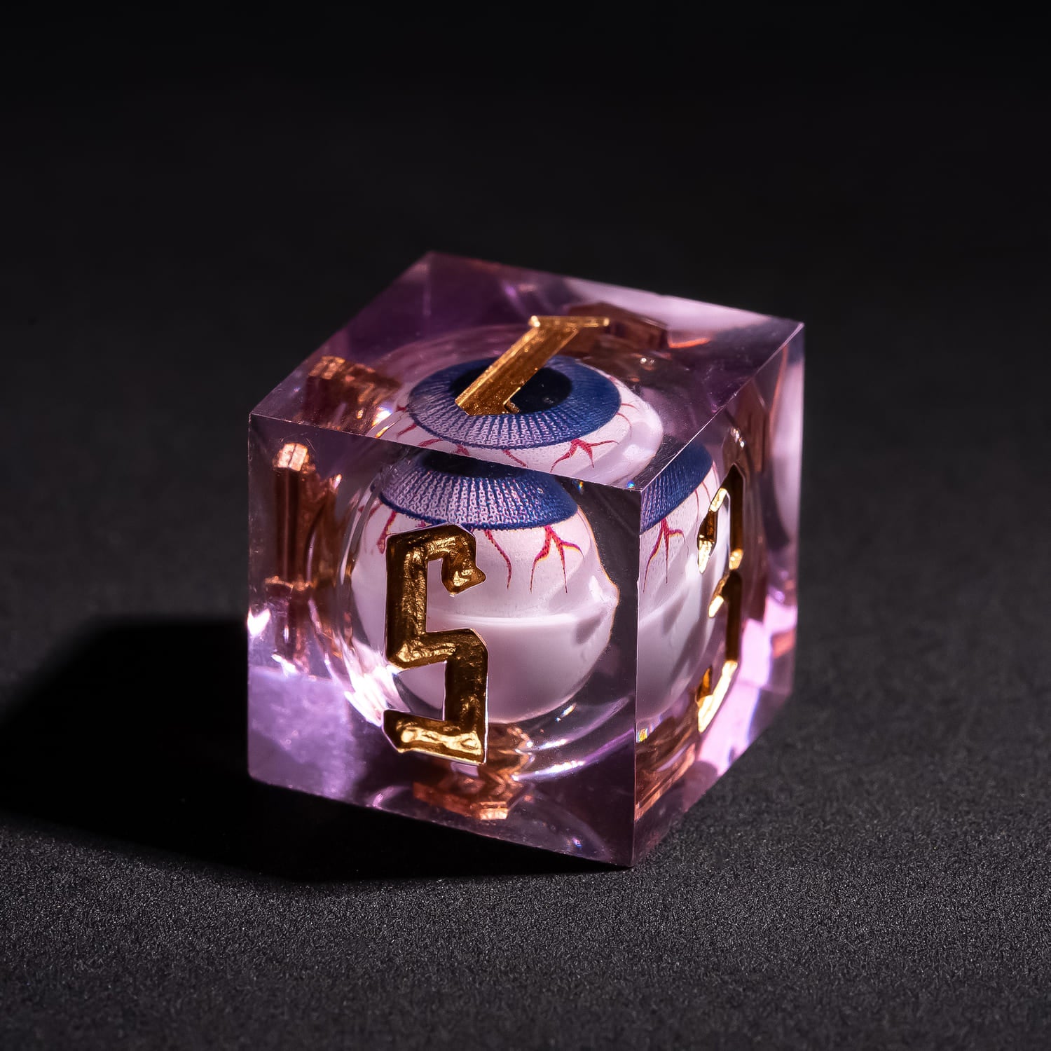 Close up of Liquid Core Eye Purple Sharp Edge D6 showing floating purple eye core inside translucent violet resin