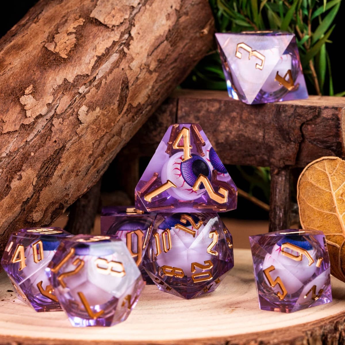 Liquid Core Eye Purple Sharp Edge Dice Set arranged on wooden surface with natural background for DnD tabletop gaming