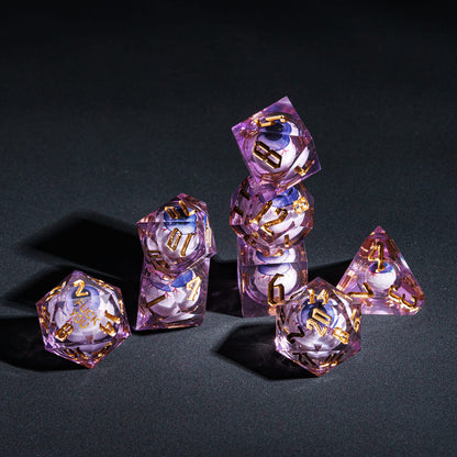 Stacked display of purple Liquid Core Eyeball Fuck You Sharp Edge Dice Set with gold numbers