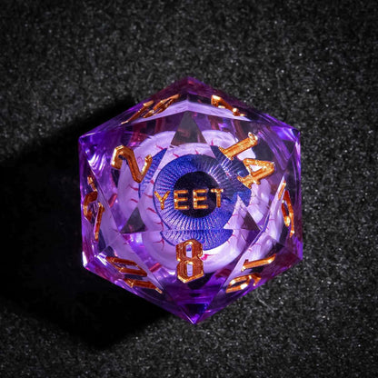 Close up of purple Liquid Core Eyeball D20 with gold numbers and YEET engraving for DnD players