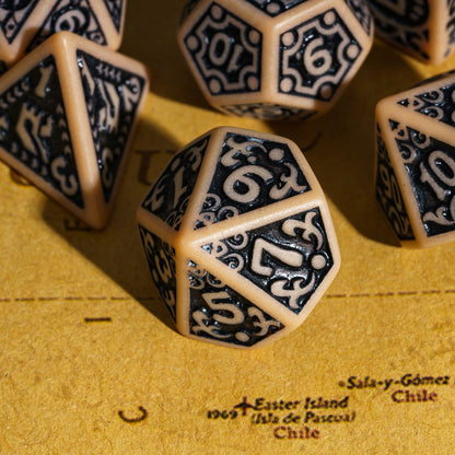 Close-up of brown Medieval Majesty d10 with black engravings, displayed on parchment