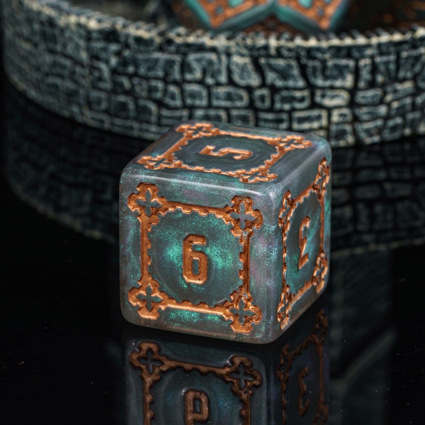 Close up of Moonlight Elixir Chonk D6 with pearlescent grey resin and metallic copper details