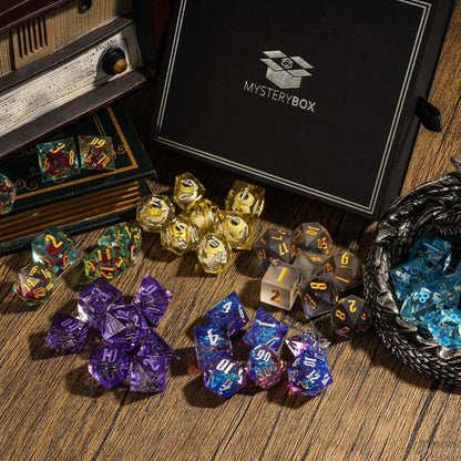 Assorted sharp edge dice sets around Only Crits Mystery Box on wooden surface