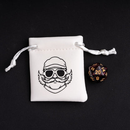 Black and gold glitter D20 die beside Only Crits dice pouch