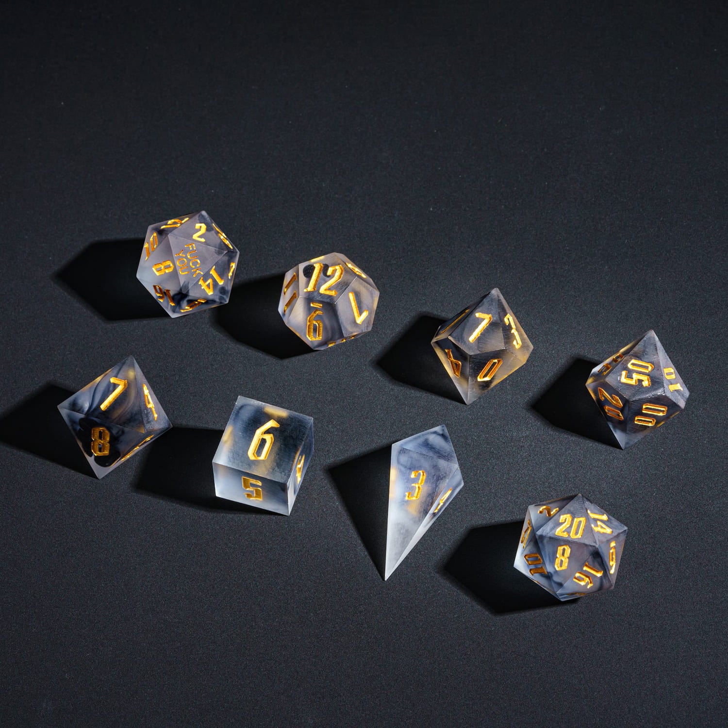 Full 7-piece Nimbus Noir F*ck Me sharp edge dice set with smoky resin and gold numbering