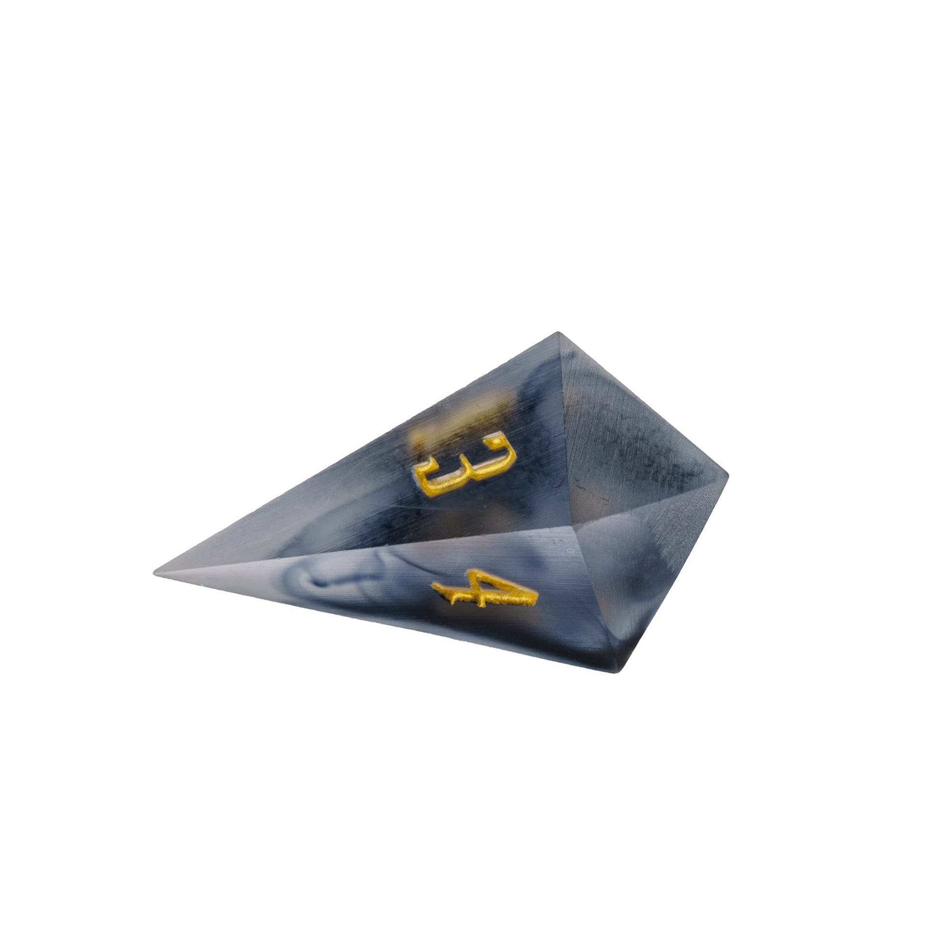 Closeup of Nimbus Noir Sharp Edge D4 die with smoky resin and gold numbering for DnD & DnD 5e