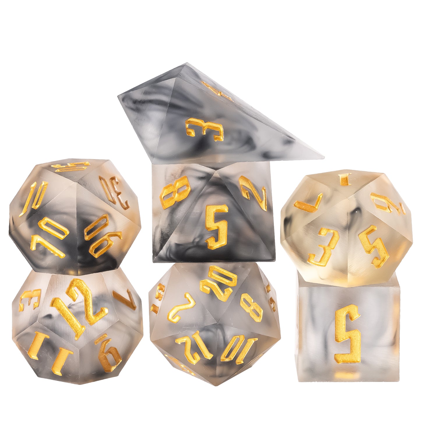 Flat lay of Nimbus Noir Sharp Edge Dice Set, translucent black and gray smoke resin with metallic gold numbers, 7 piece polyhedral dice set for DnD 