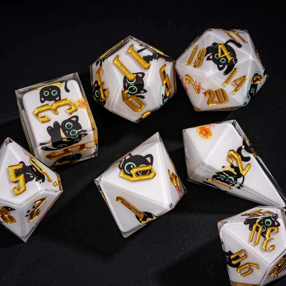 Close up of Nocturne Whiskers sharp edge dice showing black cat designs and metallic gold numbering