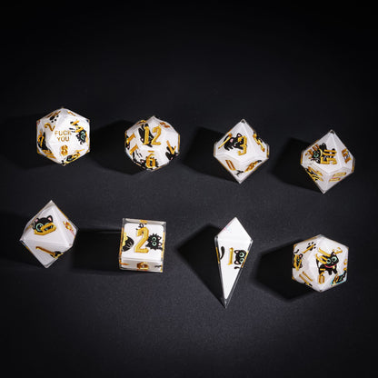 Flat lay of Nocturne Whiskers Sharp Edge Dice Set with black cat graphics and gold numbers for DnD