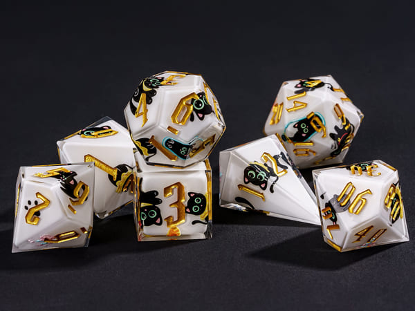 Nocturne Whiskers sharp edge dice set stacked on dark background with black cat artwork and gold numbers
