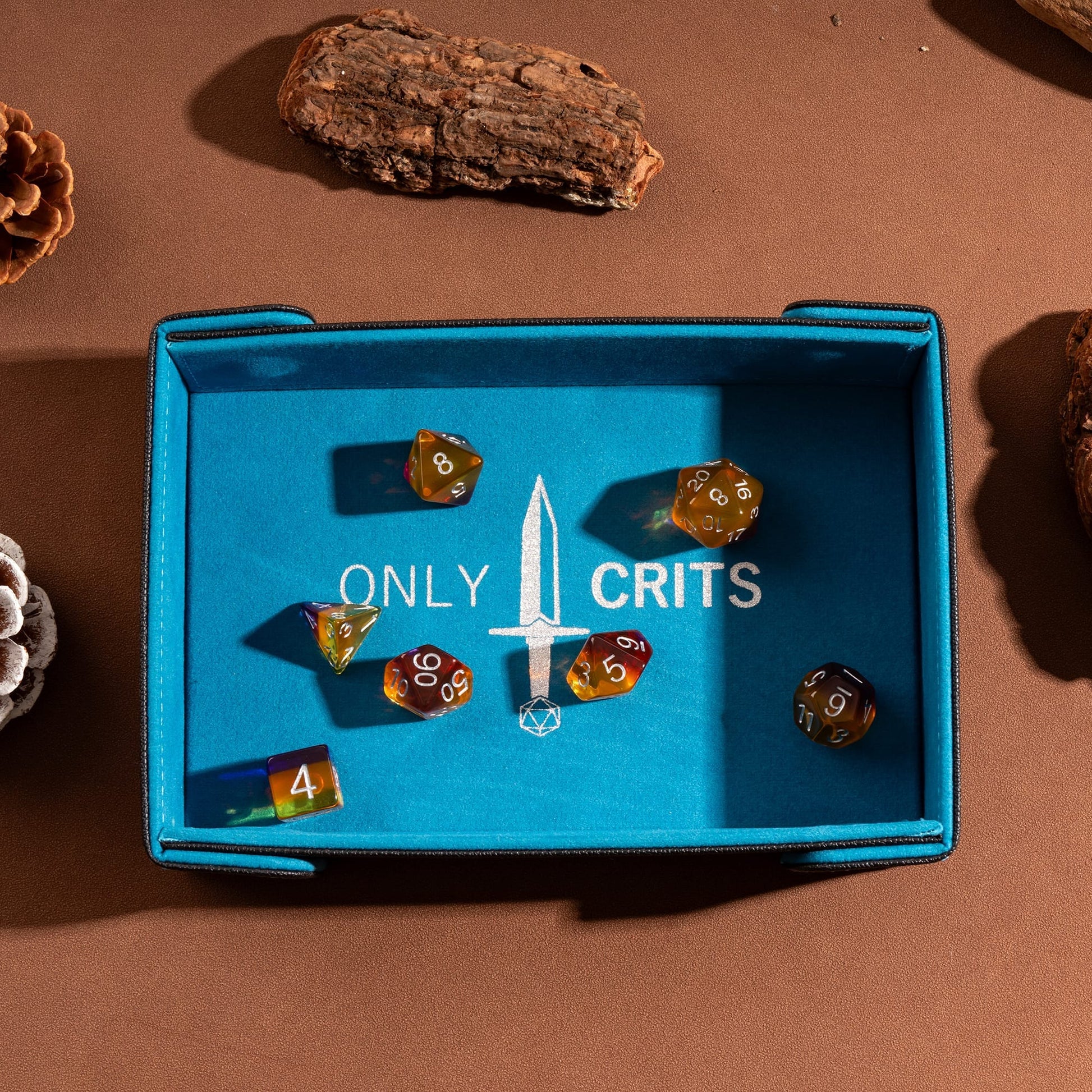 Only Crits Guildmaster Dice Tray in blue with colorful RPG dice on a soft protective rolling surface