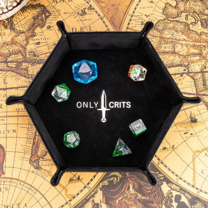 Black hexagon dice tray with Only Crits logo, top view with dice inside on fantasy map