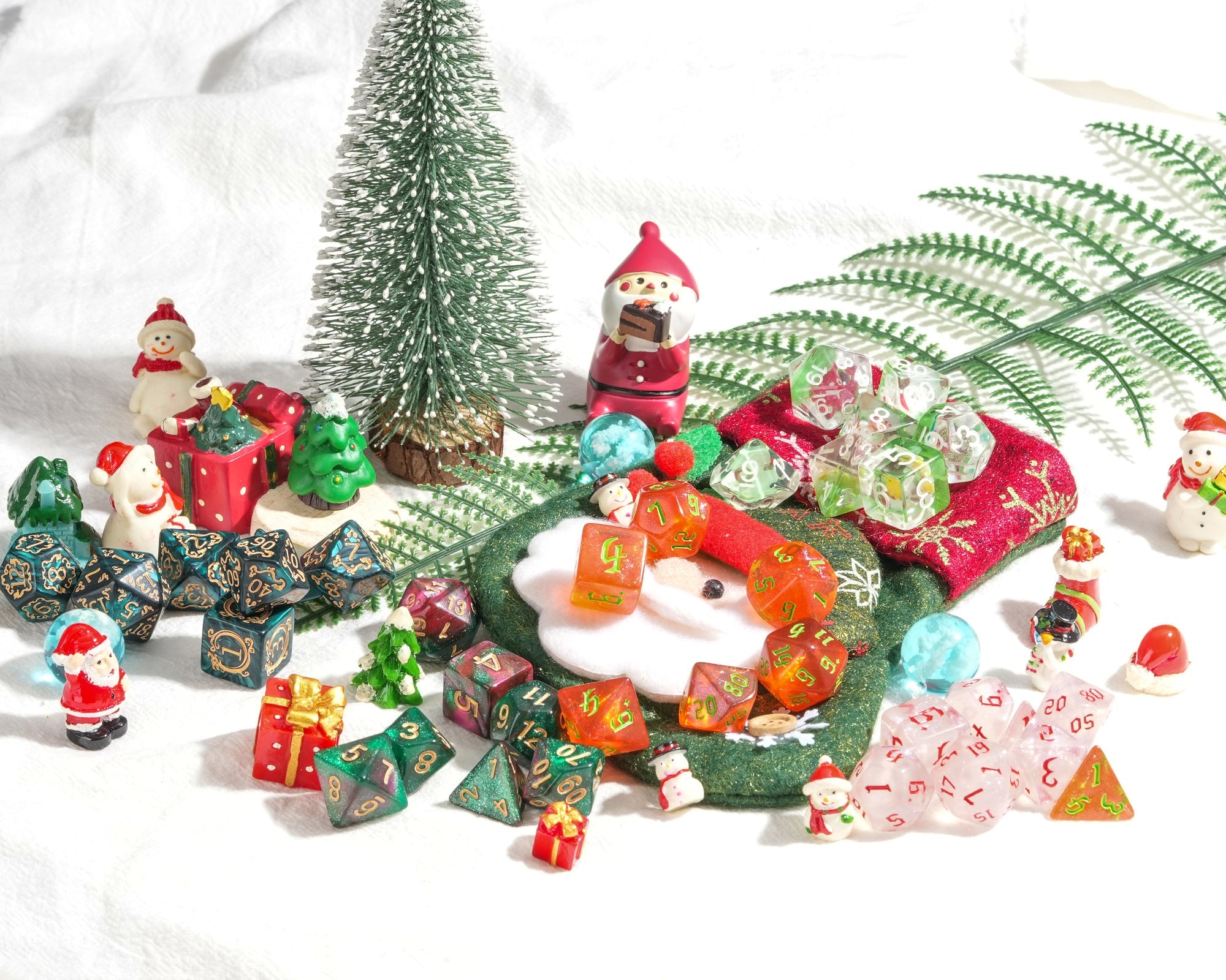 Collection of Christmas-themed decorative items including Santa Claus figurines, trees, and gift boxes on a white background.