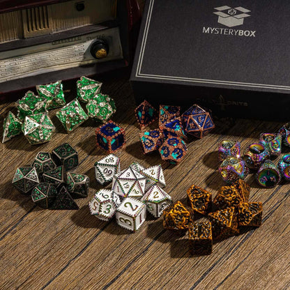 Assorted metal dice sets around Only Crits Mystery Box on wooden table