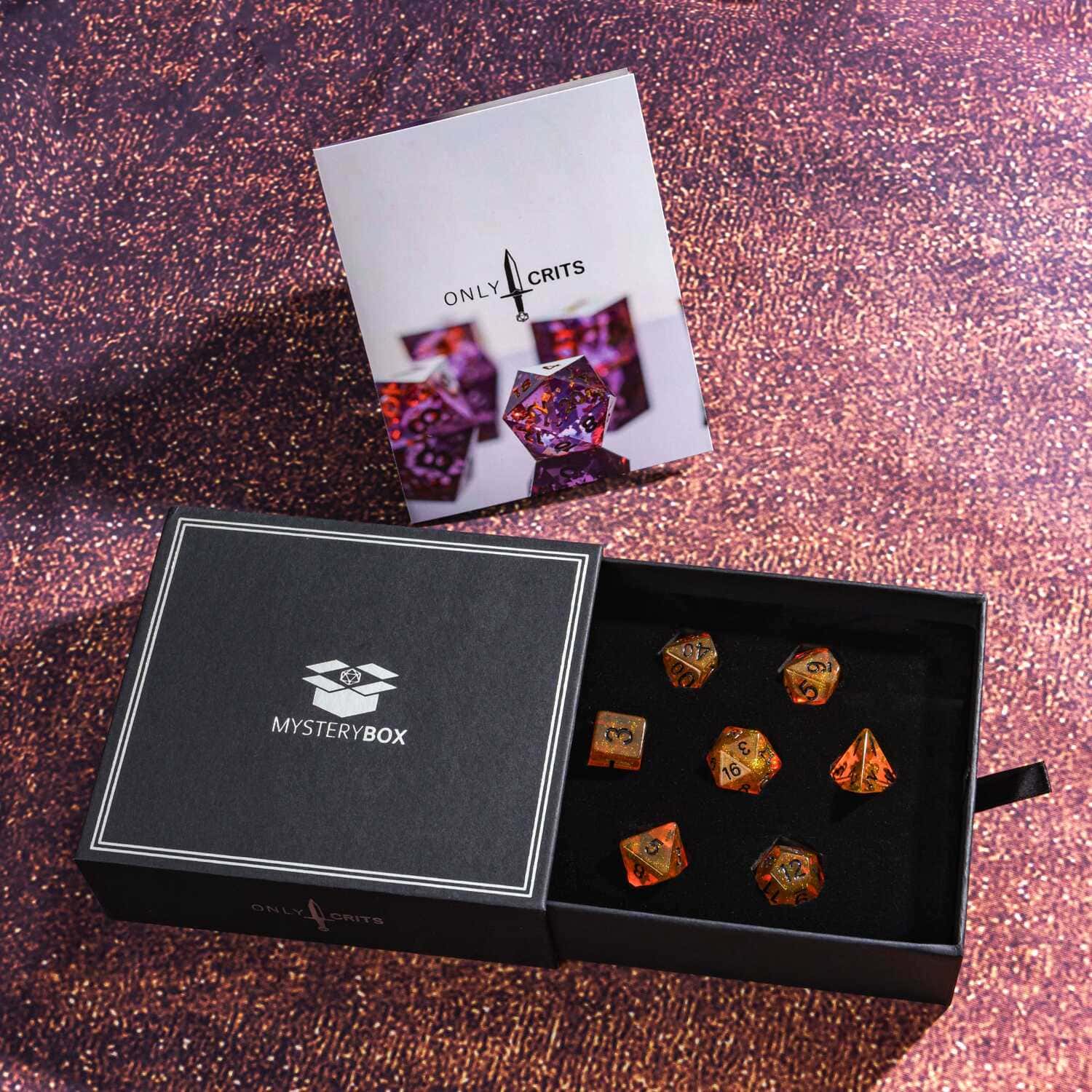 Open Only Crits Mystery Box with purple resin dice and product booklet