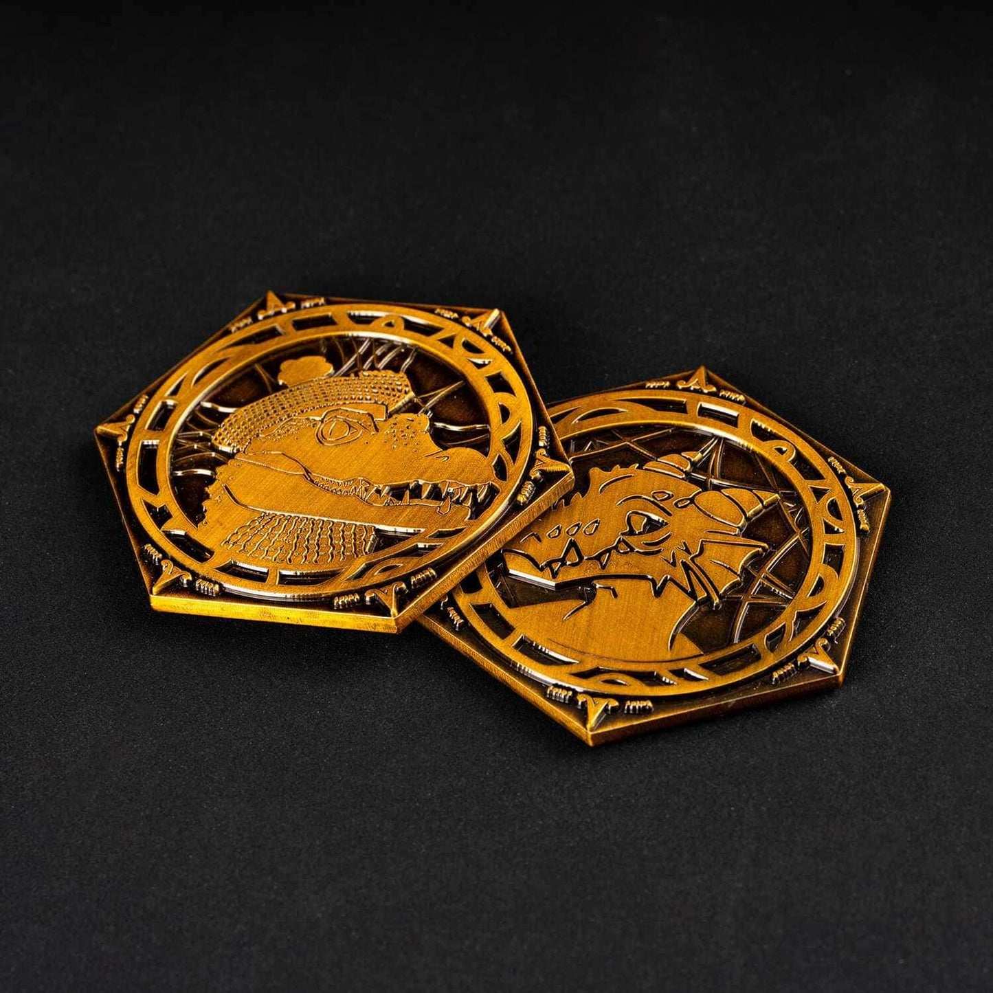 Angled view of Pack Tactics Coin showing both engraved sides in gold metal finish