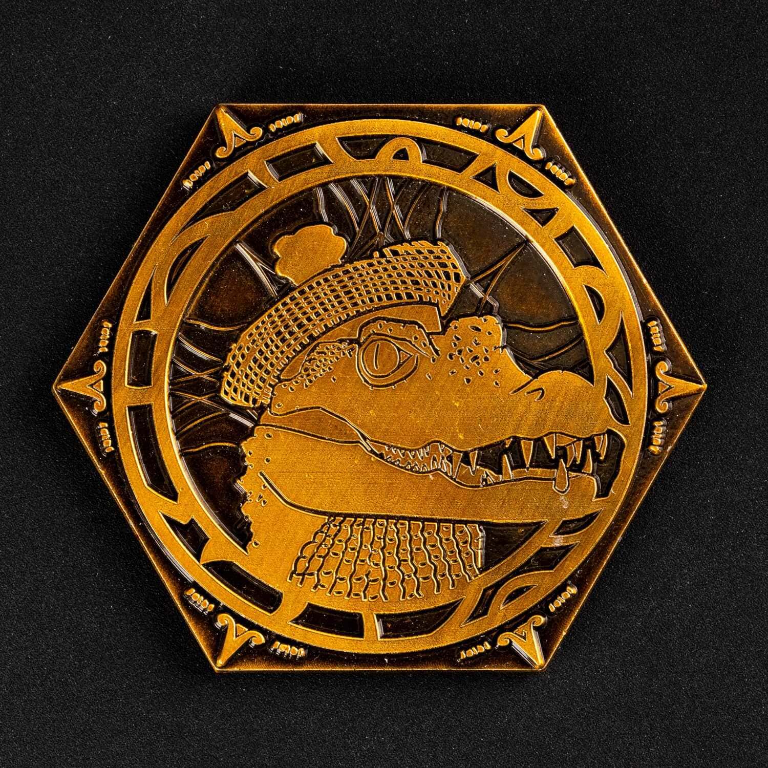 Close up of gator side on gold metal Pack Tactics inspiration coin