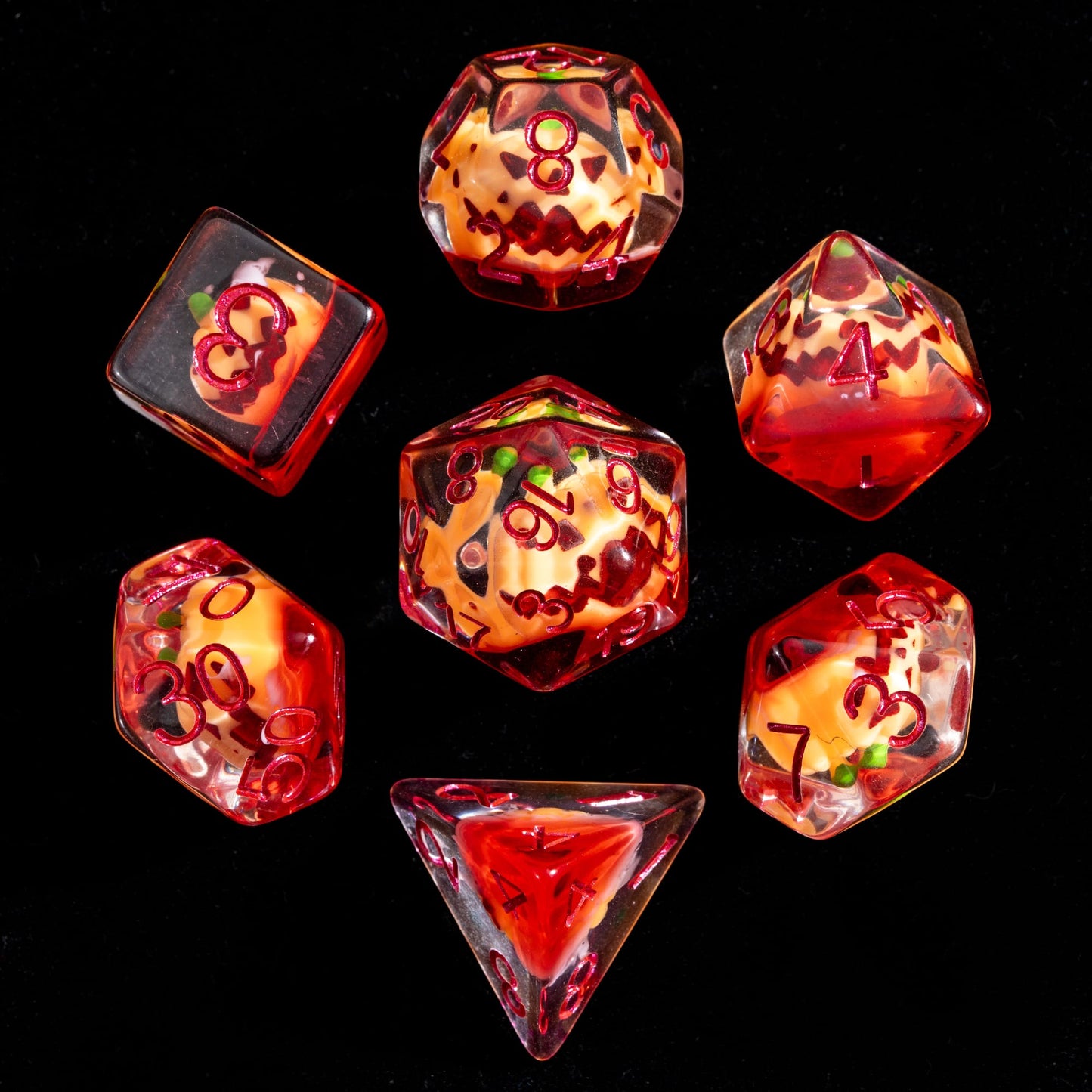 Flat lay of Pumpkin Lantern dice set on black background for DnD and DnD 5e