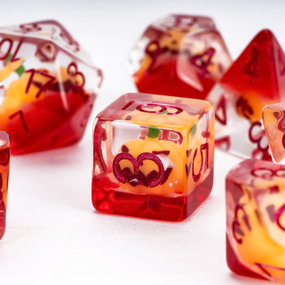 Close up of Pumpkin Lantern dice set D6 showing pumpkin inclusion in resin for DnD