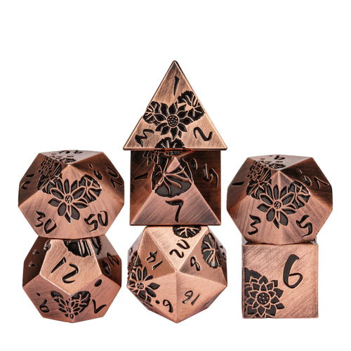 Stacked display of Rose Gold Lotus Blossom Metal Dice Set 7 piece collection for DnD & DnD 5e